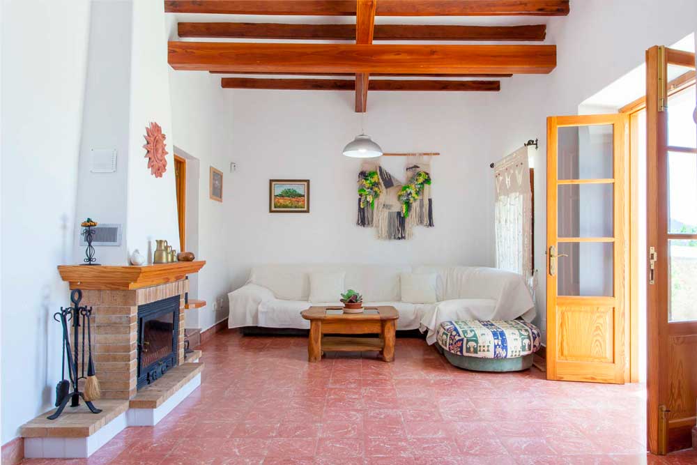 interior living room with fireplace of a rental house in ibiza